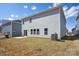 Exterior view of the backyard with a concrete patio and freshly installed AC unit at 116 Obadiah Ct, Mooresville, NC 28115
