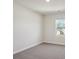Minimalist bedroom with neutral carpet, a window view, and freshly painted walls at 116 Obadiah Ct, Mooresville, NC 28115