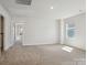 Spacious bedroom features neutral carpeting and lots of natural light from the large window at 116 Obadiah Ct, Mooresville, NC 28115