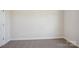 Simple bedroom featuring neutral carpet, ample natural light, and freshly painted walls at 116 Obadiah Ct, Mooresville, NC 28115