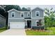 Charming two-story home with light gray siding, a two-car garage, and a well-maintained lawn at 116 Obadiah Ct, Mooresville, NC 28115