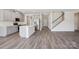 Open-concept kitchen and living space with stainless steel appliances and hardwood flooring at 116 Obadiah Ct, Mooresville, NC 28115