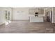 Bright living area with an open floor plan, hardwood floors, and a view of the modern kitchen at 116 Obadiah Ct, Mooresville, NC 28115