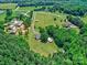 Scenic aerial shot capturing multiple homes nestled within lush greenery, offering a sense of community and private tranquility at 11850 Sugar Hill Rd, Davidson, NC 28036