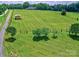 Aerial view shows a well-manicured lawn with mature trees and outbuildings; great for outdoor enjoyment or quiet contemplation at 11850 Sugar Hill Rd, Davidson, NC 28036