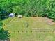 A verdant backyard featuring lush grass, a playset, and storage buildings, creating a perfect space for Gathering fun and outdoor activities at 11850 Sugar Hill Rd, Davidson, NC 28036