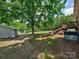 Backyard featuring a deck, shed, lush lawn, and a swing set at 11850 Sugar Hill Rd, Davidson, NC 28036