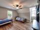 Large bedroom with hardwood floors, natural light, and comfortable beds at 11850 Sugar Hill Rd, Davidson, NC 28036