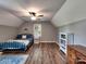 Cozy bedroom featuring a ceiling fan, window, hard wood floors, and a charming horse art piece at 11850 Sugar Hill Rd, Davidson, NC 28036