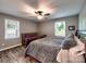 Comfortable bedroom featuring hardwood floors, ceiling fan, and natural light from two windows at 11850 Sugar Hill Rd, Davidson, NC 28036