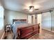 Bright bedroom featuring hardwood floors, ceiling fan, a barn door to Primary bath and large bed at 11850 Sugar Hill Rd, Davidson, NC 28036