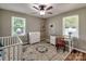 Cozy bedroom with hardwood floors, a crib, dresser, and plenty of natural light at 11850 Sugar Hill Rd, Davidson, NC 28036