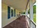 Relaxing covered front porch with wooden rocking chairs and view of the green lawn at 11850 Sugar Hill Rd, Davidson, NC 28036