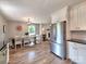 Open floor plan with stainless steel refrigerator and a dining table adjacent to the kitchen at 11850 Sugar Hill Rd, Davidson, NC 28036