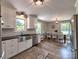 Bright kitchen featuring white cabinets, stainless steel appliances, and an open dining area at 11850 Sugar Hill Rd, Davidson, NC 28036