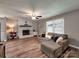Spacious living room with a stone fireplace, hardwood floors, and a comfortable sectional sofa at 11850 Sugar Hill Rd, Davidson, NC 28036