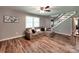 Comfortable living room with hardwood floors, a cozy couch, and a staircase at 11850 Sugar Hill Rd, Davidson, NC 28036