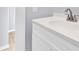 Bathroom vanity featuring a white countertop, storage, and a faucet at 12491 Oak Grove Rd, Stanley, NC 28163