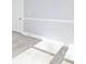 Bright bedroom featuring neutral carpet, base molding, and a door at 12491 Oak Grove Rd, Stanley, NC 28163