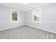 Bedroom with two windows and neutral carpet at 12491 Oak Grove Rd, Stanley, NC 28163