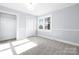 Bedroom featuring neutral walls, carpet, trim and closet at 12491 Oak Grove Rd, Stanley, NC 28163