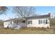Charming ranch home featuring a covered front porch and mature landscaping at 12491 Oak Grove Rd, Stanley, NC 28163