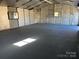 Interior view of a spacious and empty garage at 12491 Oak Grove Rd, Stanley, NC 28163