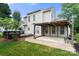 The property showcases a backyard with a covered patio area, a wooden deck and mature trees at 12824 Harvest Time Ct, Charlotte, NC 28278