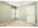 Bedroom with a window with blinds, carpet, pale green walls, and a white door at 12824 Harvest Time Ct, Charlotte, NC 28278