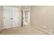 Bedroom with light-colored walls, closet, carpet flooring, and view of multiple rooms at 12824 Harvest Time Ct, Charlotte, NC 28278
