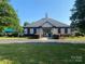 Community clubhouse featuring covered entry, manicured landscaping, and close proximity to neighborhood pool at 12824 Harvest Time Ct, Charlotte, NC 28278
