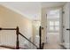 Bright foyer with staircase, chandelier, and views of the living room and entryway at 12824 Harvest Time Ct, Charlotte, NC 28278
