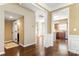 Hallway with hardwood floors and views of the kitchen and front entryway at 12824 Harvest Time Ct, Charlotte, NC 28278