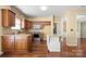 Well-equipped kitchen with stainless steel appliances, wood cabinets, and hardwood floors at 12824 Harvest Time Ct, Charlotte, NC 28278
