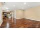 Open-concept living area with hardwood floors that leads to a modern kitchen at 12824 Harvest Time Ct, Charlotte, NC 28278