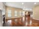 Open-concept living area with hardwood floors seamlessly connecting to the modern kitchen at 12824 Harvest Time Ct, Charlotte, NC 28278
