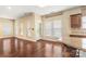 Living area featuring hardwood floors, natural light, and a view into the kitchen at 12824 Harvest Time Ct, Charlotte, NC 28278