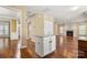 Open-concept kitchen/living area featuring hardwood floors, an island, and fireplace at 12824 Harvest Time Ct, Charlotte, NC 28278