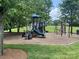 Community playground featuring multiple slides, climbing equipment, and adjacent green space at 12824 Harvest Time Ct, Charlotte, NC 28278