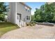 Gray two story home with hardscape patio and fenced yard at 13107 Heath Grove Dr, Huntersville, NC 28078