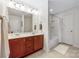 Bathroom featuring a double vanity, large mirror, and a shower-tub combination at 13107 Heath Grove Dr, Huntersville, NC 28078
