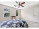 Bright bedroom featuring two windows, a cozy bed, and neutral decor, perfect for relaxation at 13107 Heath Grove Dr, Huntersville, NC 28078