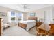 Inviting bedroom with large windows, wooden bed, and a charming chair, filled with natural light at 13107 Heath Grove Dr, Huntersville, NC 28078