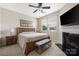 Comfortable bedroom featuring a fireplace, ceiling fan, and natural light from a window at 13107 Heath Grove Dr, Huntersville, NC 28078