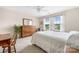 Bright bedroom with natural light, a comfortable bed, wooden dresser, and elegant window curtains at 13107 Heath Grove Dr, Huntersville, NC 28078