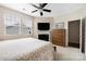 Cozy bedroom with a ceiling fan, fireplace, and a large window for natural light at 13107 Heath Grove Dr, Huntersville, NC 28078