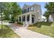 Inviting two-story home featuring a covered porch, landscaped garden beds, and a neatly manicured front yard at 13107 Heath Grove Dr, Huntersville, NC 28078