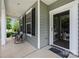 Relaxing front porch with seating area and a clear view to the outside, accessible through the glass front door at 13107 Heath Grove Dr, Huntersville, NC 28078