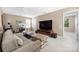 Spacious living room features a comfortable couch, workspace, and a large entertainment center at 13107 Heath Grove Dr, Huntersville, NC 28078