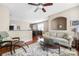 Open-concept living room with hardwood floors, a comfortable seating area, and seamless access to the dining area at 13107 Heath Grove Dr, Huntersville, NC 28078